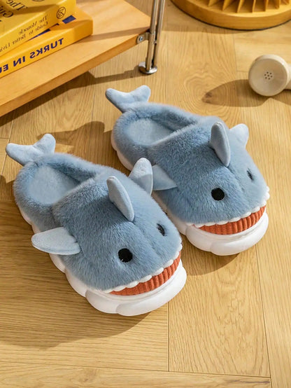 Plush blue shark slippers on wood floor
